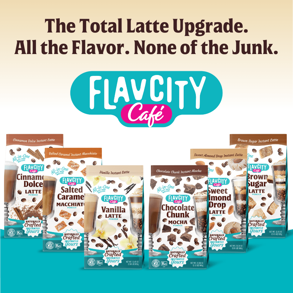 Five FlavCity Cafe Vanilla Latte drink mix packages are lined up beneath the text: The Total Latte Upgrade. Made with grass-fed whole milk and real coffee. The background features teal and cream colors.