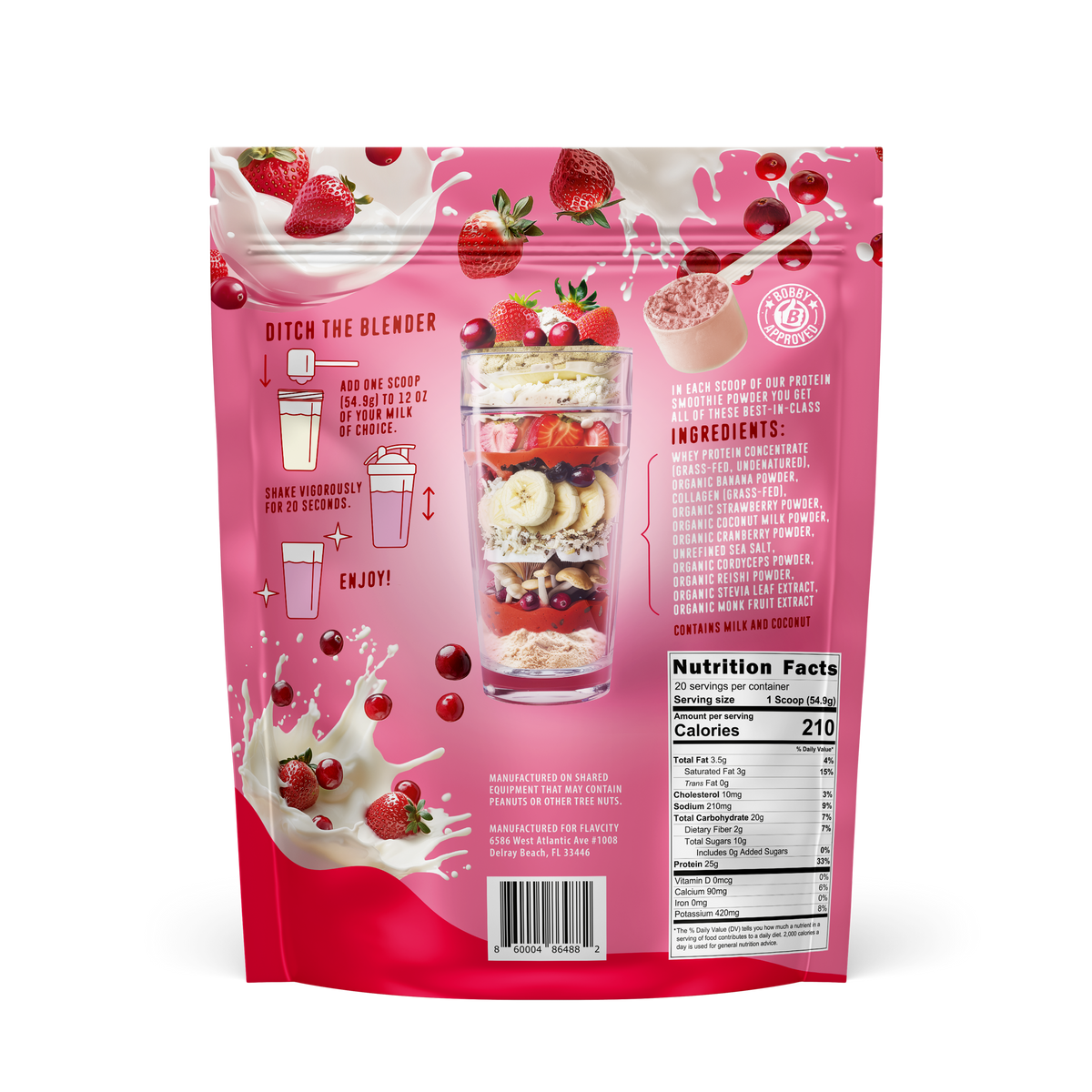 Back of FlavCity Berries and Cream protein smoothie powder package displaying nutrition information, layered smoothie glass, and floating strawberries with milk splashes on pink background.