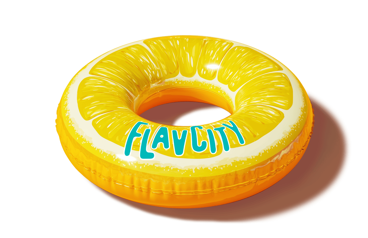 Yellow inflatable pool float shaped like a lemon slice with “FLAVCITY” in blue letters, casting a shadow on a white background. Fun summer swim accessory.