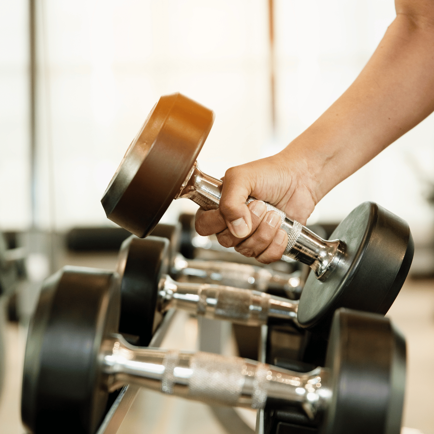 A man taking a dumbell.