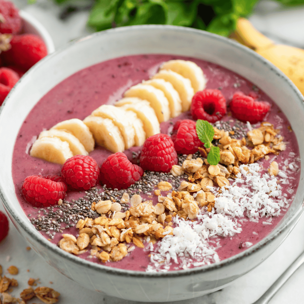 A  bowl of strawberries, banana and nuts.