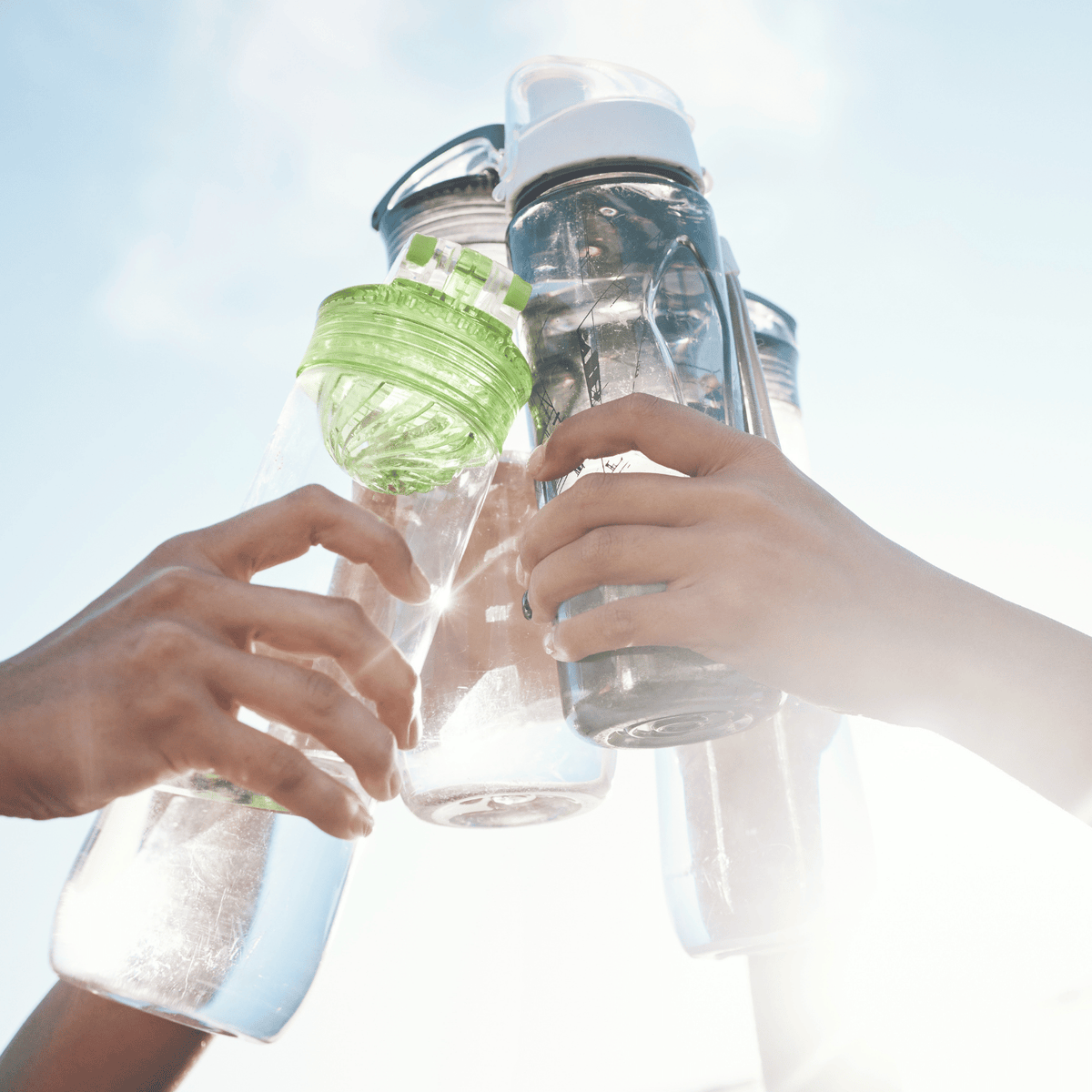 Toasting with bottles of water.