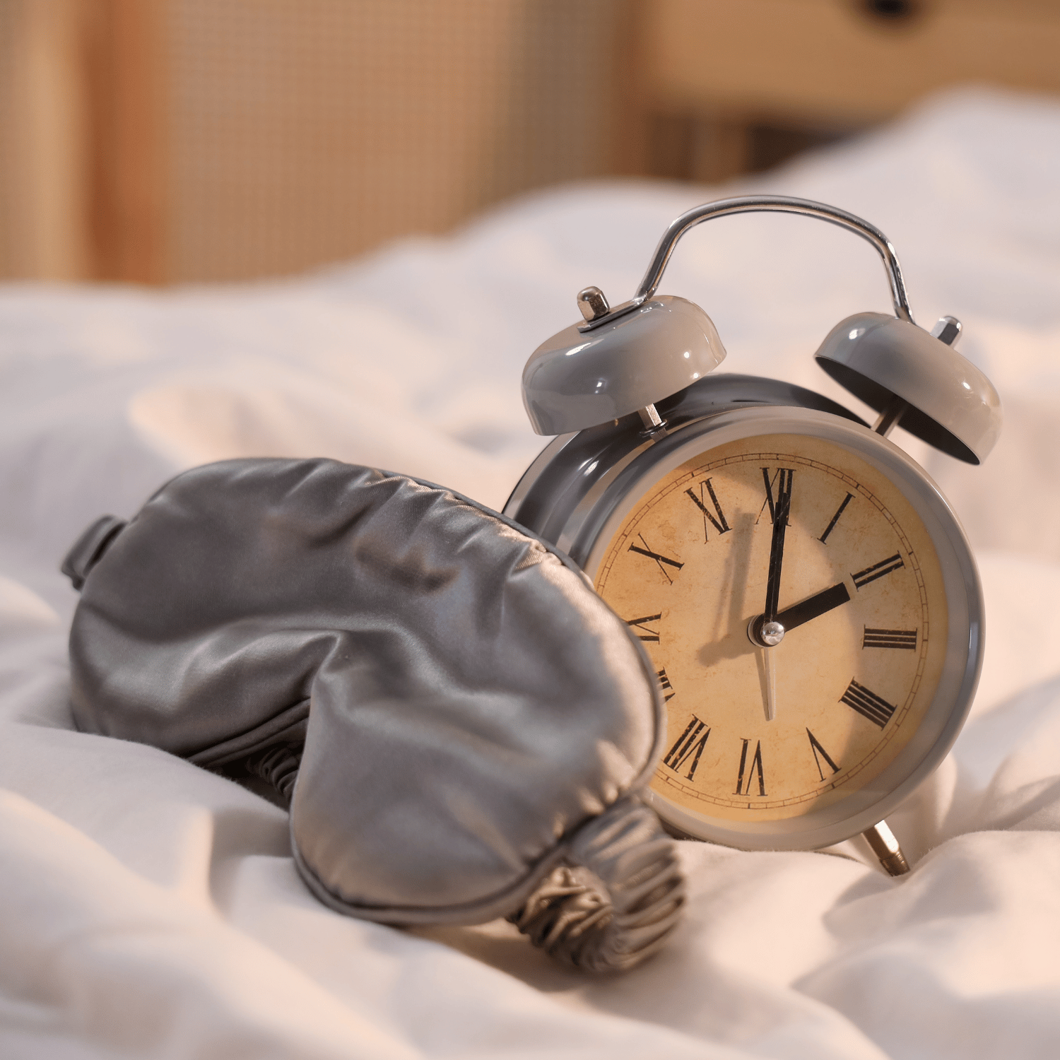 A clock and a sleeping eye mask.