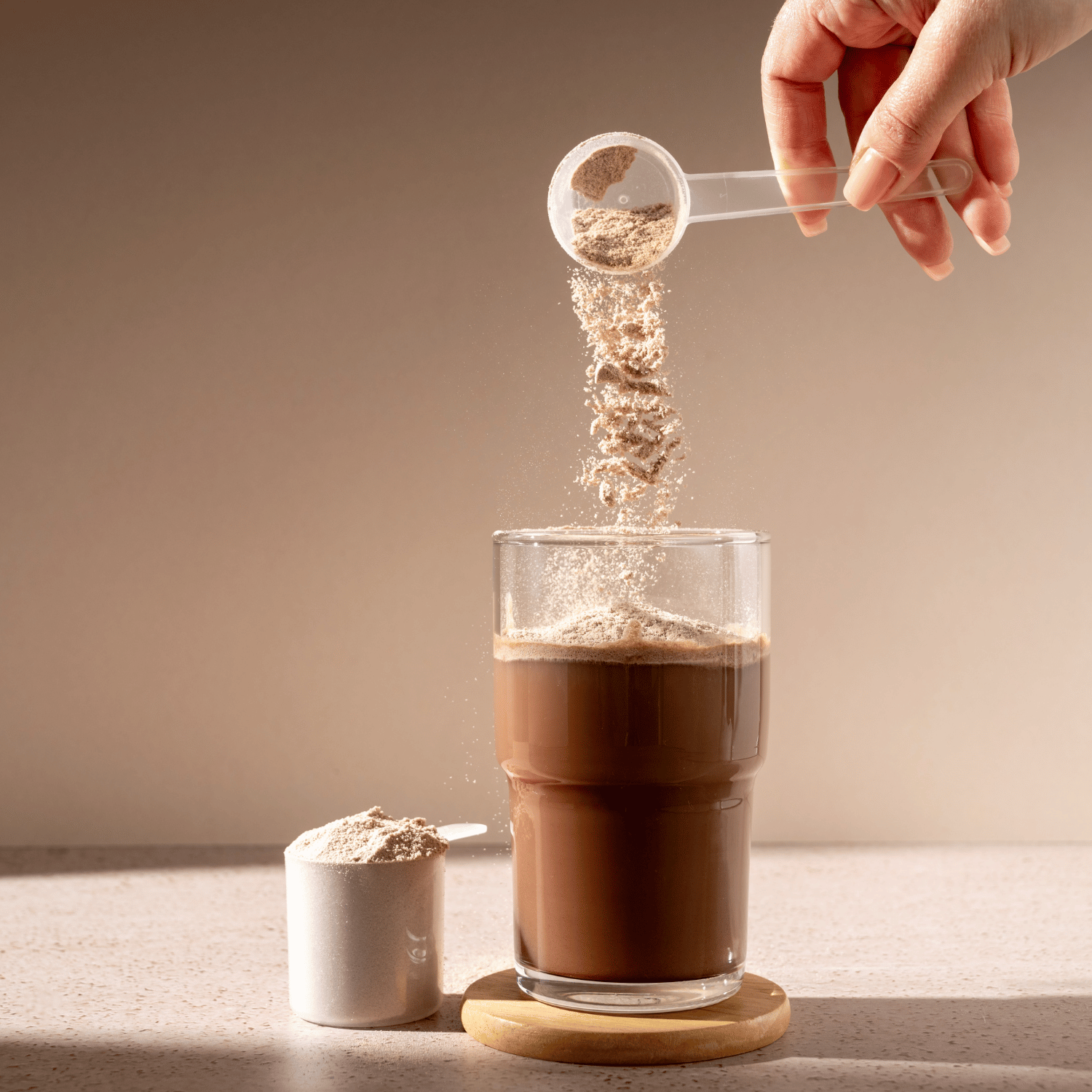 Pouring a chocolate flavor protein powder.