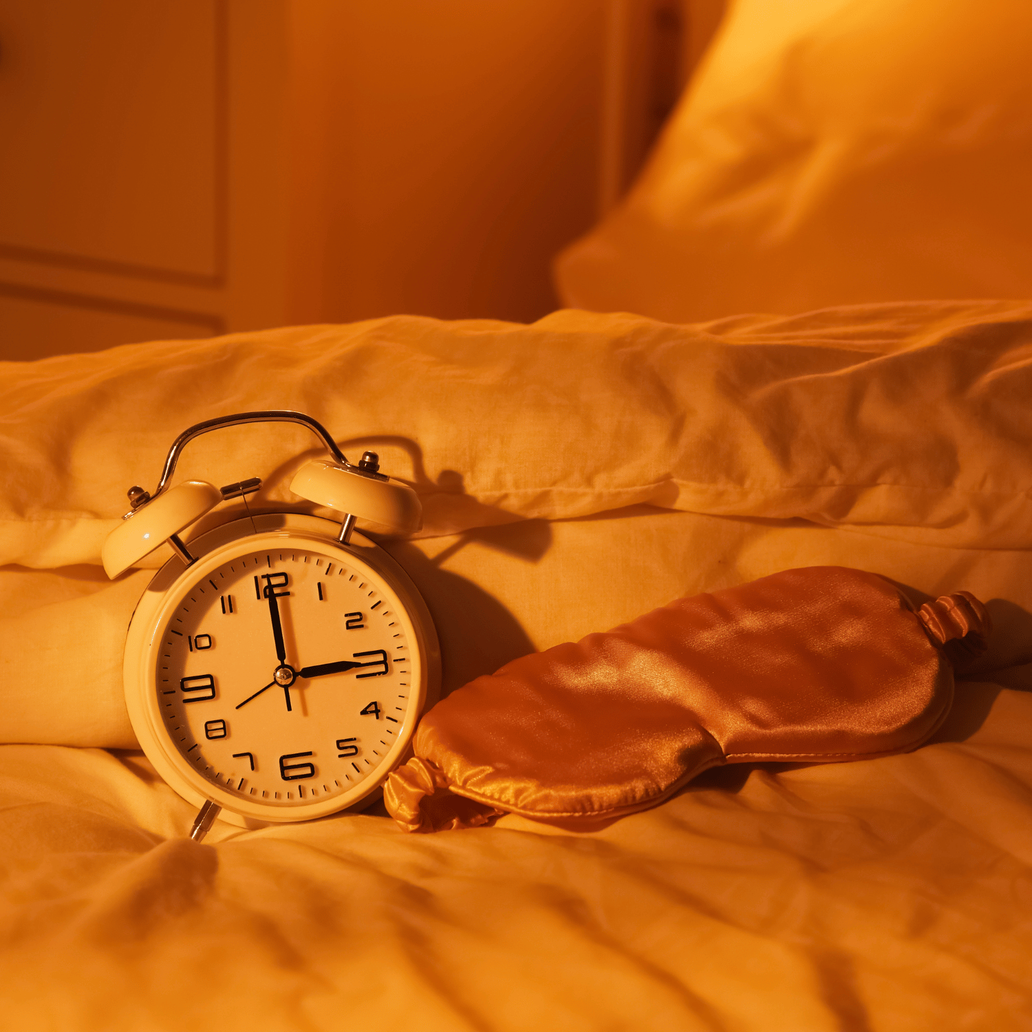 A clock on the bed.