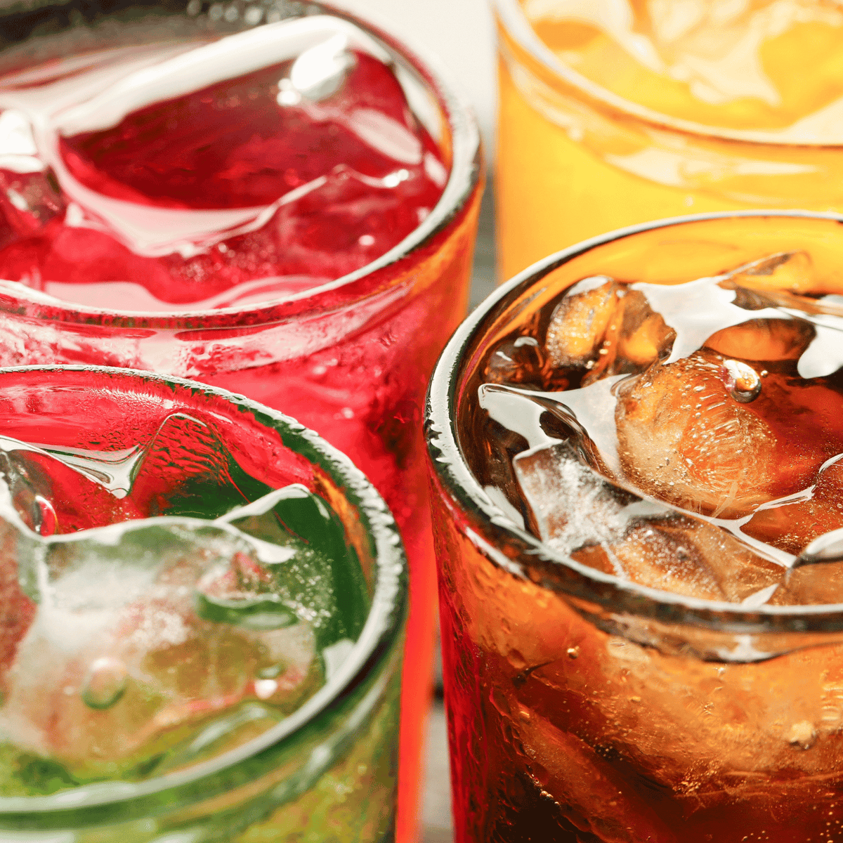 Different flavors of juice in a glass of water.