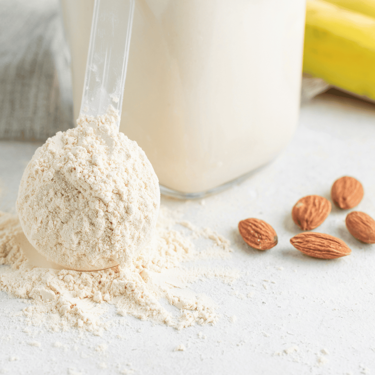 A scoop of protein powder, almonds and a banana.
