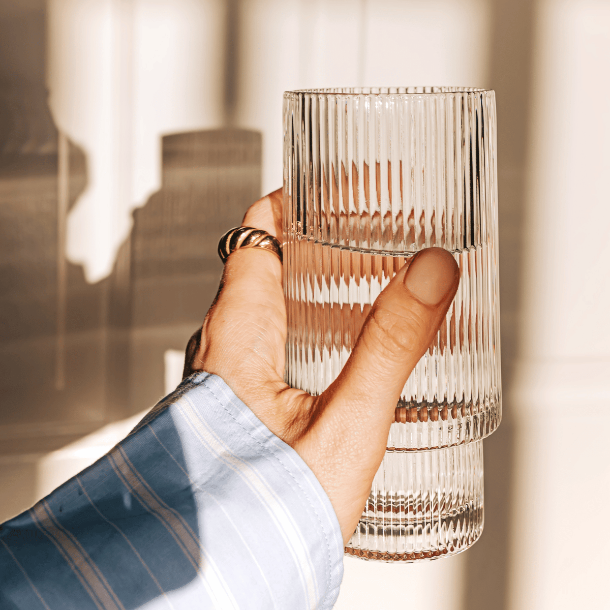 Holding a glass of water.