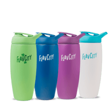Four Shop FlavCity Shaker Bottles in green, blue, purple, and white are lined up. Each reusable insulated bottle features a flip lid and is designed for lump-free shakes with the FLAVCITY logo in matching or contrasting colors.