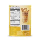 A yellow packet of Shop FlavCity Banana Bread Protein Smoothies features a parfait image with bananas, granola, and cookies. The nutrition facts label indicates 180 calories per serving, and both the barcode and manufacturer information appear at the bottom.