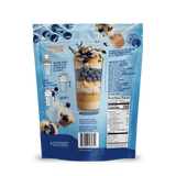 A blue Shop FlavCity Blueberry Muffin Protein Smoothie package shows a clear glass with layered smoothie, fresh blueberries, and highlights of collagen protein and grass-fed whey, plus mixing instructions, ingredients, and nutrition facts on the back.