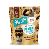 A Shop FlavCity Butter Coffee Protein Smoothie pouch featuring images of coffee, butter, and a glass layered with banana slices and chocolate chunks, formulated with grass-fed whey.
