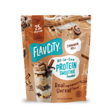 Pouch of FlavCity Cinnamon Roll Protein Smoothie featuring images of a cinnamon roll, cinnamon sticks, and a glass layered with banana slices and smoothie mix.