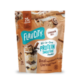 Pouch of FlavCity Cinnamon Roll Protein Smoothie featuring images of a cinnamon roll, cinnamon sticks, and a glass layered with banana slices and smoothie mix.
