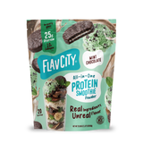 A pouch of Shop FlavCity Mint Chocolate Protein Smoothie powder, featuring images of a chocolate mint cookie, scoops of mint chip ice cream, a glass of the blended drink, and mint leaves to highlight this grass-fed whey and collagen blend.