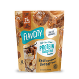 A pouch of FlavCity Salted Caramel Protein Smoothie powder featuring caramel cubes, a glass of smoothie, and text highlighting 25 grams of protein and 10 grams of collagen.