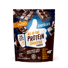 FlavCity chocolate protein smoothie powder package front with breaking chocolate bars imagery. Features 25g protein, 10g collagen per serving, made with grass-fed whey and cocoa on dark blue background with chocolate splash effects.