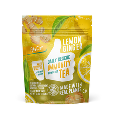 FlavCity Daily Rescue Immunity Tea powder packet in Lemon Ginger flavor, featuring turmeric and MCT oil, 30 servings of vegan and non-GMO dietary supplement with no added sugar, packaged in a yellow resealable pouch with green leaf accents and lemon slice graphics