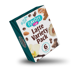 A tilted box of FlavCity Cafe Latte Variety Pack features six latte flavors, with images of coffee beans, cinnamon, almond, cookie, vanilla flower, and chocolate on the packaging against a white background.