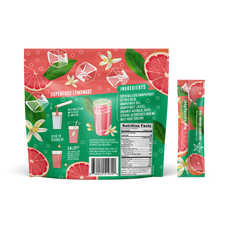 A vibrant Shop FlavCity Grapefruit Lemonade sugar-free superfood mix pack features sliced grapefruit, leaves, and flowers. The front displays a glass of pink lemonade with ice, while the back lists ingredients, instructions, and nutrition facts.