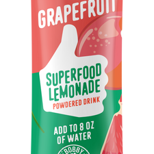 A vibrant packet of Shop FlavCity Grapefruit Lemonade, decorated with grapefruit, a flower, and green leaves. This sugar-free drink is Bobby Approved—just mix with 8 oz water. Net wt: 2.4g.