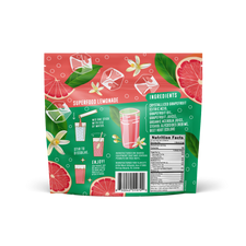 A vibrant Shop FlavCity Grapefruit Lemonade mix package features citrus and grapefruit slice graphics, ice cubes, and flowers. Directions, ingredients, and nutrition facts are displayed next to a glass of pink lemonade with a stir stick.