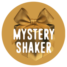 A gold gift box with a large bow is centered in a gold circle, featuring the words "Shop FlavCity Mystery Shaker" in bold white letters across the front.