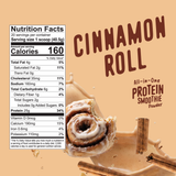 Nutrition facts label for a Shop FlavCity Cinnamon Roll Protein Smoothie, featuring an image of a cinnamon roll with icing splashing into a pool of drink mix.