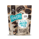 A bag of Shop FlavCity Cookies & Cream Protein Smoothie, made with grass-fed whey and 10g collagen, is pictured next to tasty cookies and a creamy smoothie. The packaging showcases 25g of protein per serving from real ingredients, with each bag providing 20 servings.
