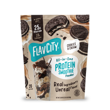 A bag of Shop FlavCity Cookies & Cream Protein Smoothie, made with grass-fed whey and 10g collagen, is pictured next to tasty cookies and a creamy smoothie. The packaging showcases 25g of protein per serving from real ingredients, with each bag providing 20 servings.