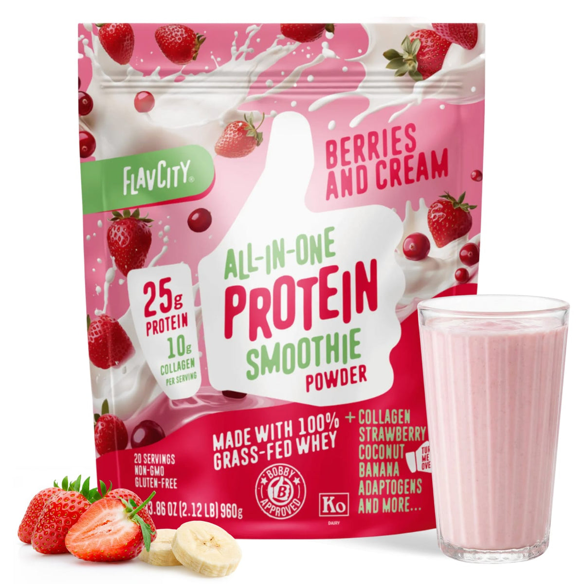 A package of Shop FlavCity Berries & Cream Protein Smoothie powder stands next to a glass of pink smoothie, surrounded by fresh strawberries and banana slices.