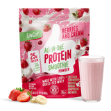 A bag of Shop FlavCity Berries & Cream Protein Smoothie sits next to a glass of pink smoothie, sliced strawberries, and banana on a white surface.