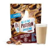 A bag of Shop FlavCity Chocolate Peanut Butter Protein Smoothie is displayed next to a glass of prepared chocolate peanut butter protein smoothie, chocolate pieces, and peanuts. The bag highlights 25g grass-fed whey protein and 10g collagen per serving.