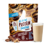 A bag of Shop FlavCity Chocolate Peanut Butter Protein Smoothie is displayed next to a glass of prepared chocolate peanut butter protein smoothie, chocolate pieces, and peanuts. The bag highlights 25g grass-fed whey protein and 10g collagen per serving.