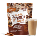 A bag of Shop FlavCity Cinnamon Roll Protein Smoothie stands behind a glass of smoothie and two cinnamon sticks, with images of cinnamon rolls and cinnamon sticks on the packaging.