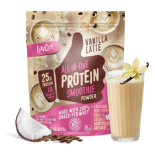 Shop FlavCity Vanilla Latte Protein Smoothie powder with coffee beans, coconut, and a glass of smoothie garnished with a vanilla flower; highlights include 25g protein and collagen per serving from grass-fed whey.