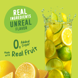 A tall glass of Shop FlavCity Lemon Lime Electrolyte Mix splashes with liquid, surrounded by lemon and lime slices, with text reading Real ingredients, unreal flavor, 0g added sugar, and made with real fruit.