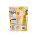 A pouch of Shop FlavCity Pineapple Coconut Electrolyte Mix showing nutrition facts, ingredients, and directions alongside pineapple slices and coconut chunks.