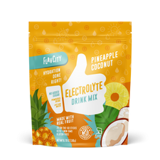 FlavCity Pineapple Coconut Electrolyte Drink Mix in a resealable yellow and orange bag. The design features a white thumb-up graphic and text promoting 'Hydration done right,' 'No added sugar,' 'Made with real fruit,' and 'Bobby Approved,' with illustrations of pineapple slices, coconut halves, and tropical leaves.