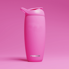 A pink shaker bottle with a flip-top lid stands upright against a matching pink background. The word PROMiXX is printed in white and green letters near the bottom of the bottle.
