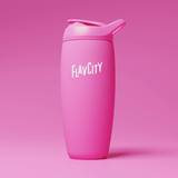 A pink reusable tumbler with a flip-top lid and the word FLAVCITY printed in white on the front, set against a matching pink background.