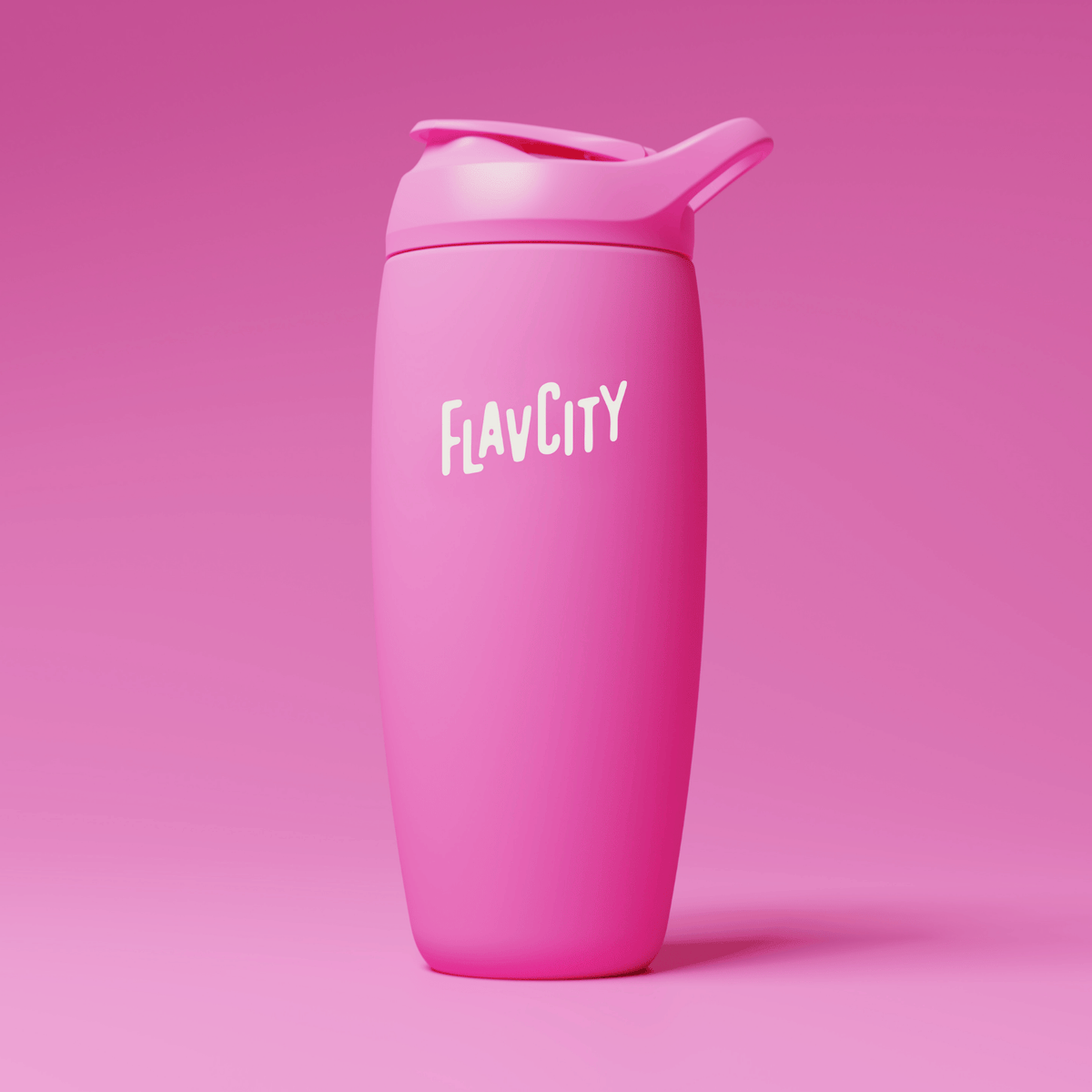 A pink reusable tumbler with a flip-top lid and the word FLAVCITY printed in white on the front, set against a matching pink background.