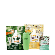 The Shop FlavCity Lucky Blend Shamrock Smoothie Bundle features limited edition Shamrock Protein Smoothie, Vanilla Cream, Chocolate protein powders (25g grass-fed whey each), and a green shaker bottle, all displayed on a white background.