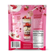 Back panel of FlavCity Berries and Cream protein smoothie powder packet. Features preparation instructions with simple icons showing how to add packet to 12 oz liquid and shake. Lists premium ingredients including grass-fed whey protein, collagen, and organic superfoods. Nutrition facts panel shows 210 calories and 25g protein per serving. Pink background with floating strawberries, cranberries and milk splashes. Manufacturing information and barcode visible at bottom.
