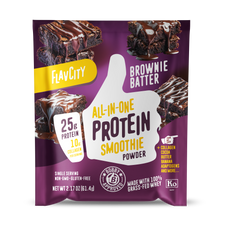 Front panel of FlavCity Brownie Batter all-in-one protein smoothie powder single-serving packet. Features 25g protein, 10g collagen per serving. Non-GMO, gluten-free, grass-fed whey product. Purple packaging with dripping chocolate brownies imagery and Bobby-approved certification seal.