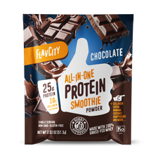 Front panel of FlavCity chocolate protein smoothie powder packet. Features white thumbs-up logo with ‘25g Protein’ and ‘10g Collagen’ prominently displayed. Package highlights ‘All-in-One Protein Smoothie Powder’ in bold text, includes Bobby Approved seal, and Kosher dairy certification. Shows breaking chocolate bars against deep blue background. Single-serving packet contains 57.3g of non-GMO, gluten-free powder