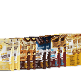 A row of Shop FlavCity Protein Smoothie 10 Single-Serve packets in flavors like Vanilla Cream, Butter Coffee, Chocolate, Chocolate Peanut Butter, and Banana Bread displayed side by side against a white background.