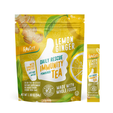 FlavCity Daily Rescue Immunity Tea package in yellow and green featuring lemon ginger flavor with turmeric and MCT oil. Contains 30 powdered tea sticks, vegan, non-GMO, no added sugar. Package shows illustrations of ginger root, lemon slices, and tea cups. Bobby approved seal visible. Net weight 1.90 oz (54g). Single serving stick packet shown next to main package.