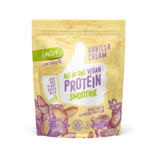 FlavCity Vanilla Cream All-in-One Vegan Protein Smoothie mix in a resealable beige and purple bag. The design features a white thumb-up graphic and text promoting 'Just add plant-based milk,' '20g protein per serving,' 'Made with almond protein,' and 'Bobby Approved,' with illustrations of vanilla flowers and almond pods.