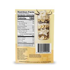 A packet of Shop FlavCity Vanilla Cream Protein Smoothie features a clear window displaying the granola, banana chips, and nuts inside. The back shows the Nutrition Facts label and barcode, while the top of the package is decorated with white flowers and antler graphics.